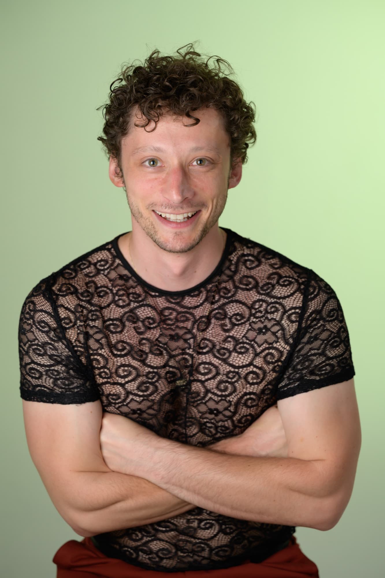 Portrait of Ben Grinberg in a black lace shirt.